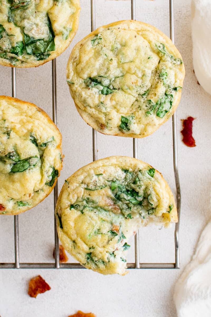 egg bites on a cooling rack with a bite taken from one