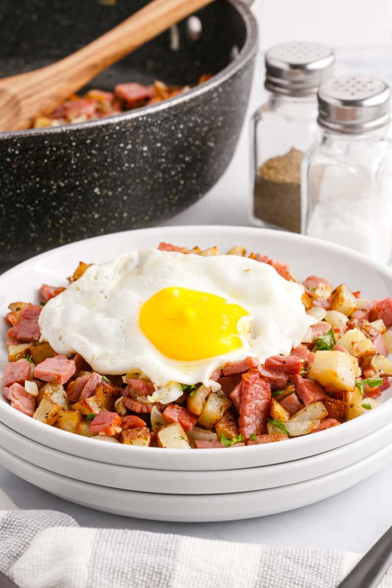 corned beef hash with a fried egg on top on a white plate