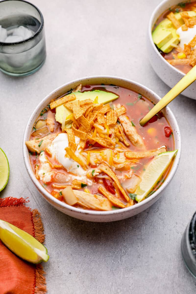 chicken tortilla soup in a white bowl with a spoon