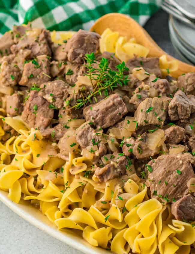 beef and noodles on a white serving platter