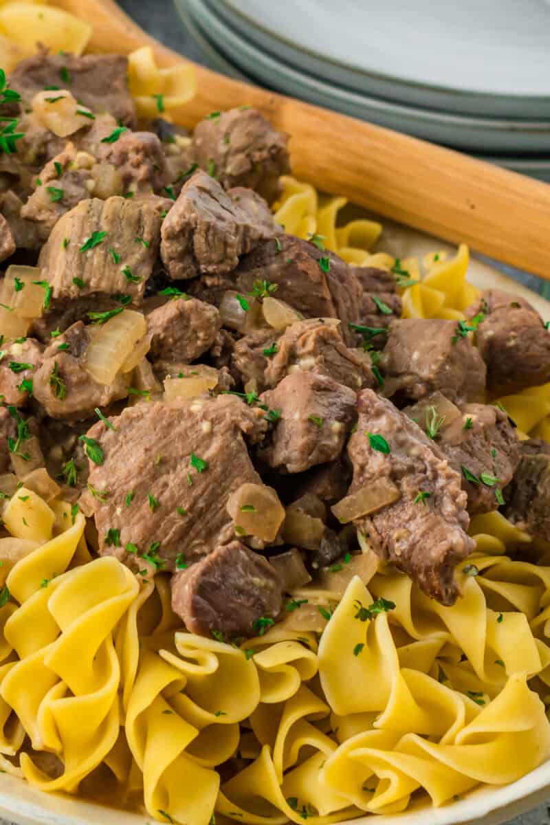 beef and noodles on a white serving platter
