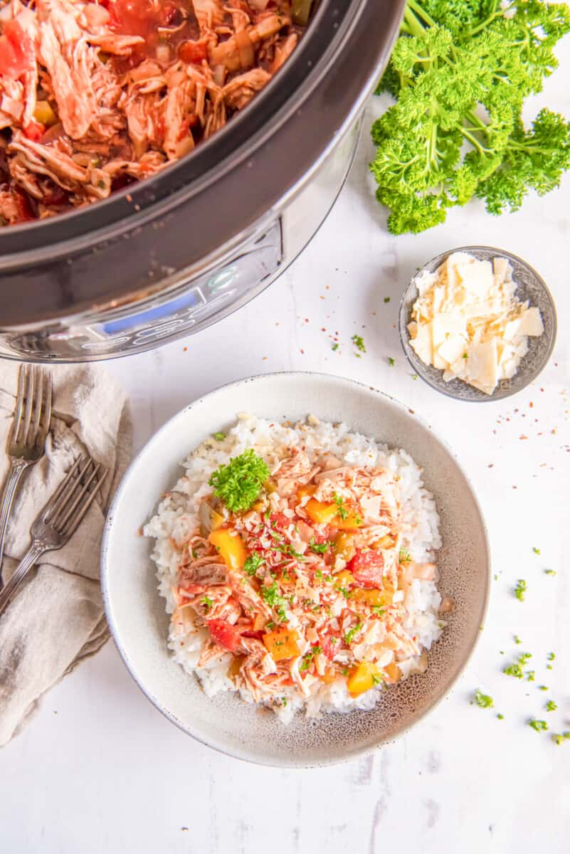 shredded italian chicken on top of rice in a bowl