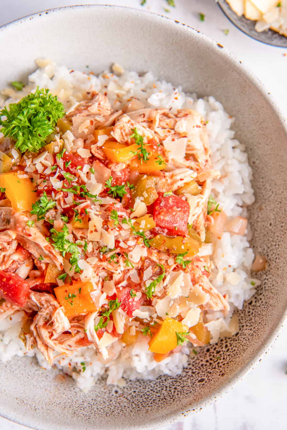 shredded italian chicken on top of rice in a bowl