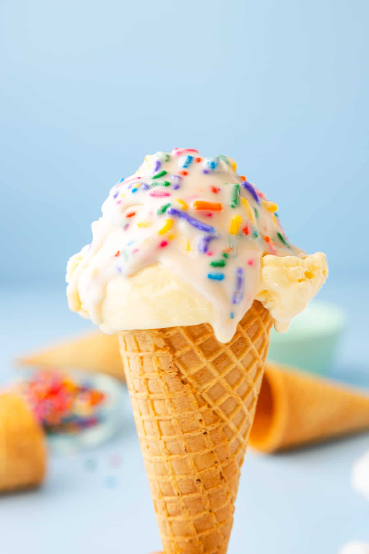 vanilla ice cream cone topped with funfetti magic shell