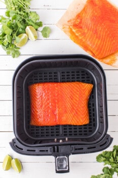 cilantro lime salmon fillet in an air fryer before cooking