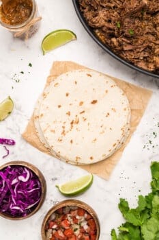 tortillas and ingredients for barbacoa tacos