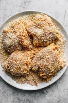 coated chicken thighs on a white plate