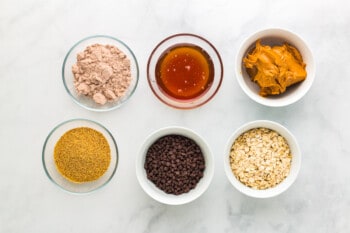 ingredients for chocolate peanut butter protein balls in bowls