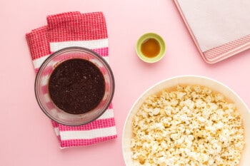 chocolate sauce for popcorn in a glass bowl and popcorn in a white bowl