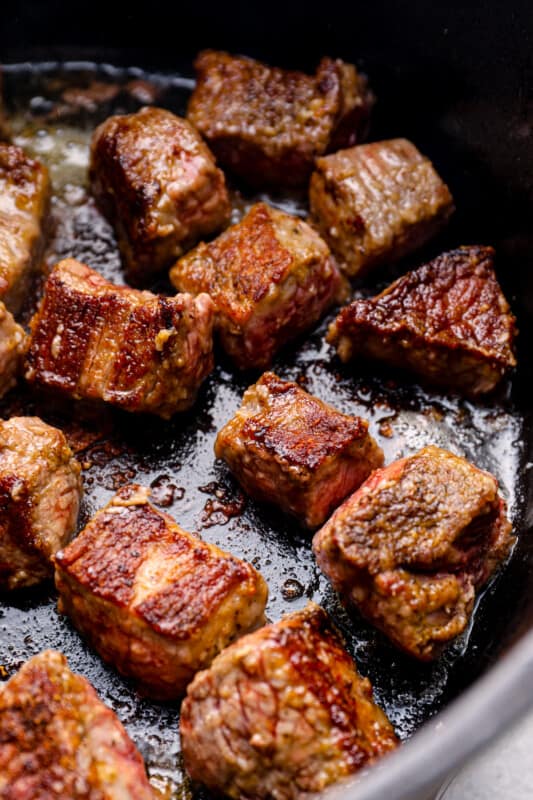 cooked beef chunks in a Dutch oven