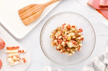 seasoned diced potatoes in a glass bowl