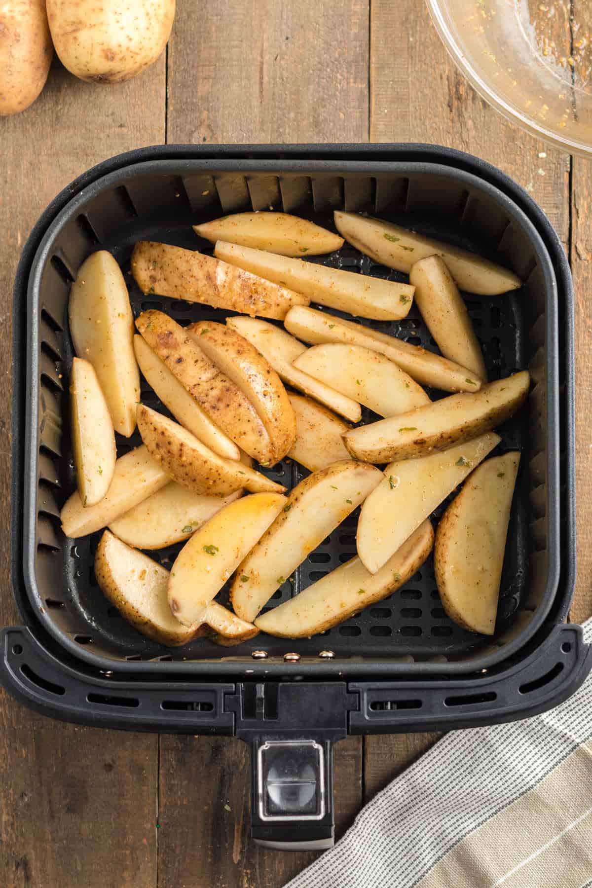 potato wedges in an air fryer before cooking