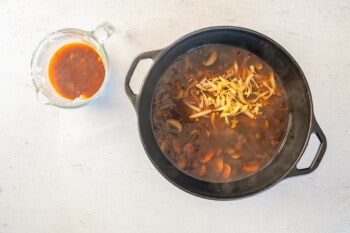 egg noodles added to a pot of beef stroganoff soup