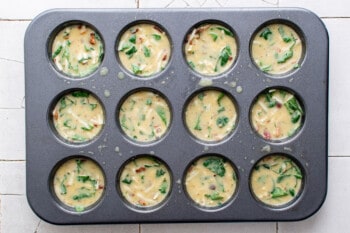 egg bites in a muffin pan before baking