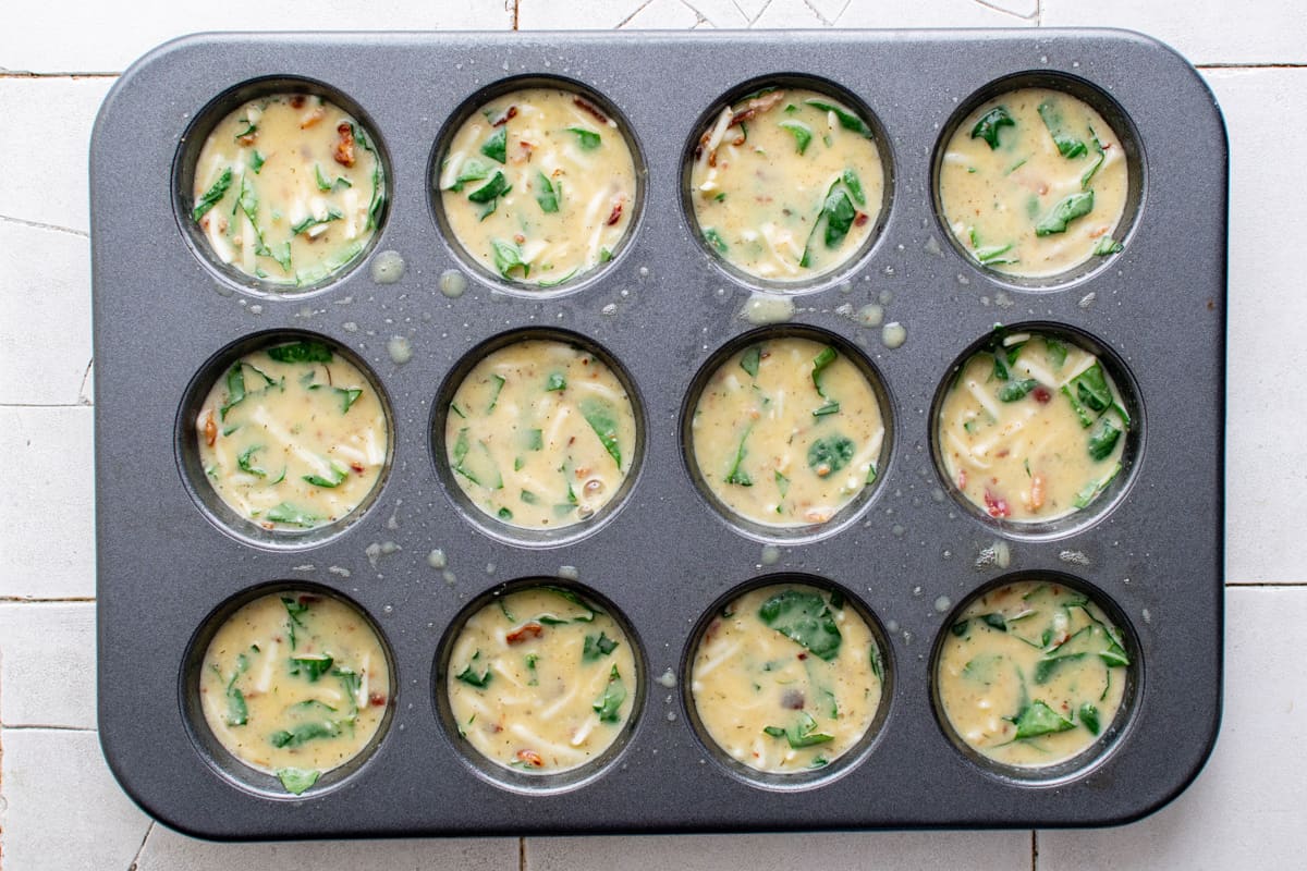 egg bites in a muffin pan before baking