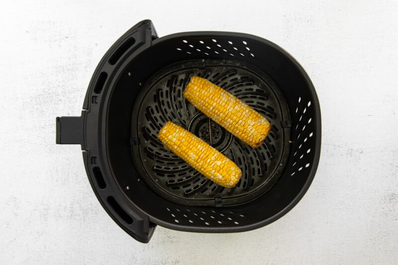 2 ears of corn on the cob in air fryer after cooking