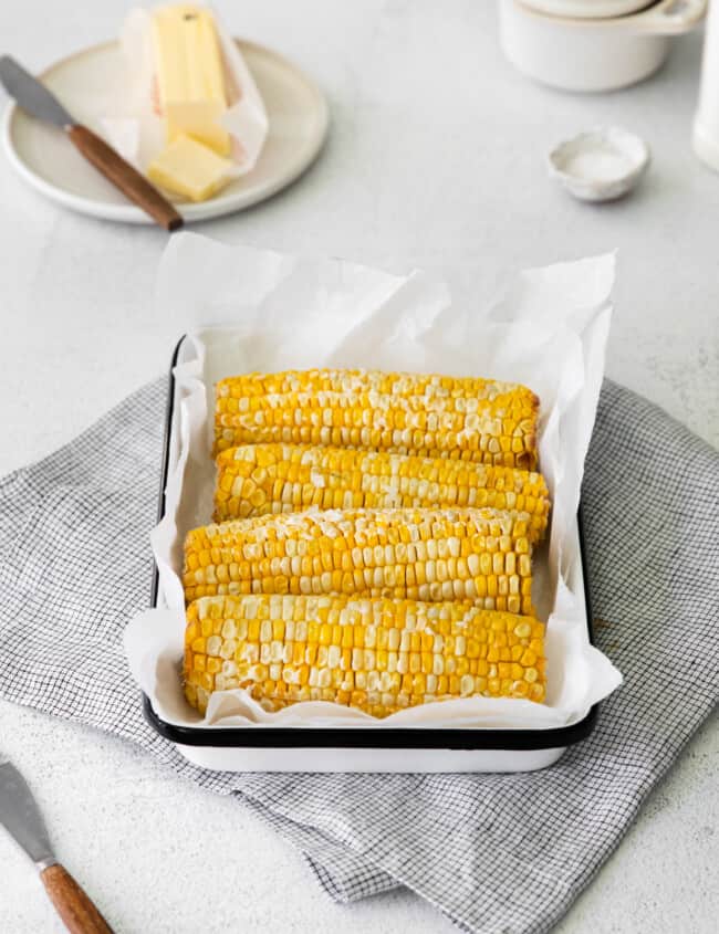 4 ears of corn on the cob on a serving platter