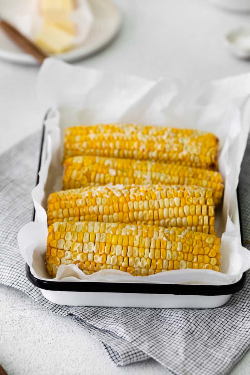 4 ears of corn on the cob on a serving platter
