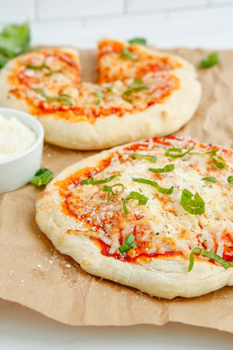 2 cheese pizzas on parchment paper