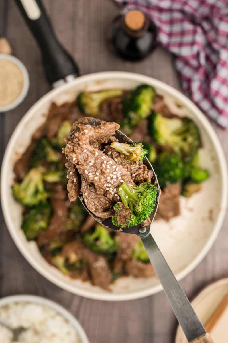 overhead image of a serving spoon with beef and broccoli