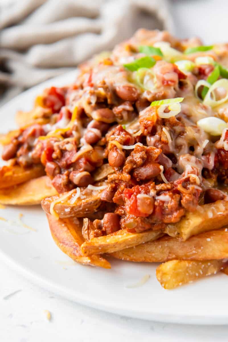 chili cheese fries on a white plate