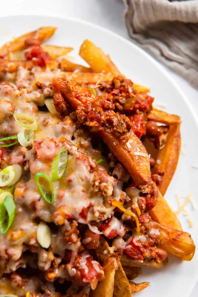 chili cheese fries on a white plate