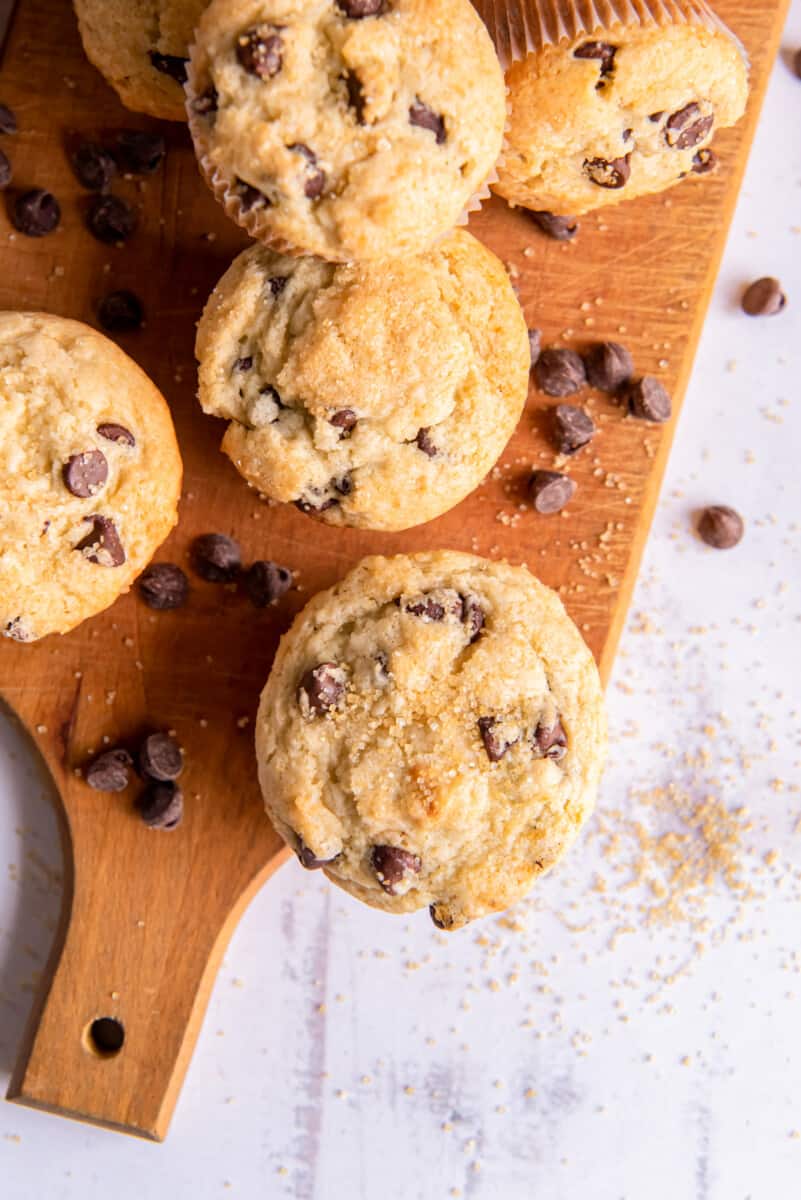 overhead image of chocolate chip muffins on a wood board