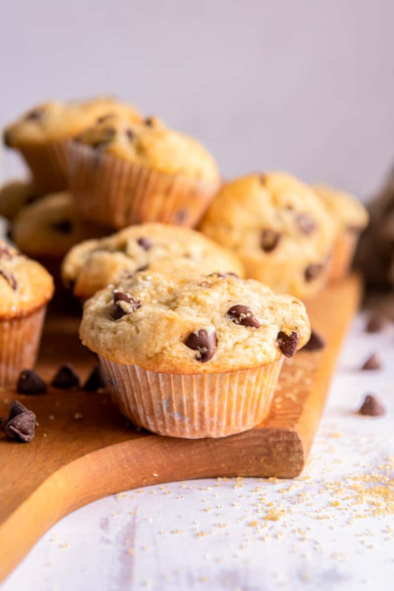 chocolate chip muffins on a wood serving board