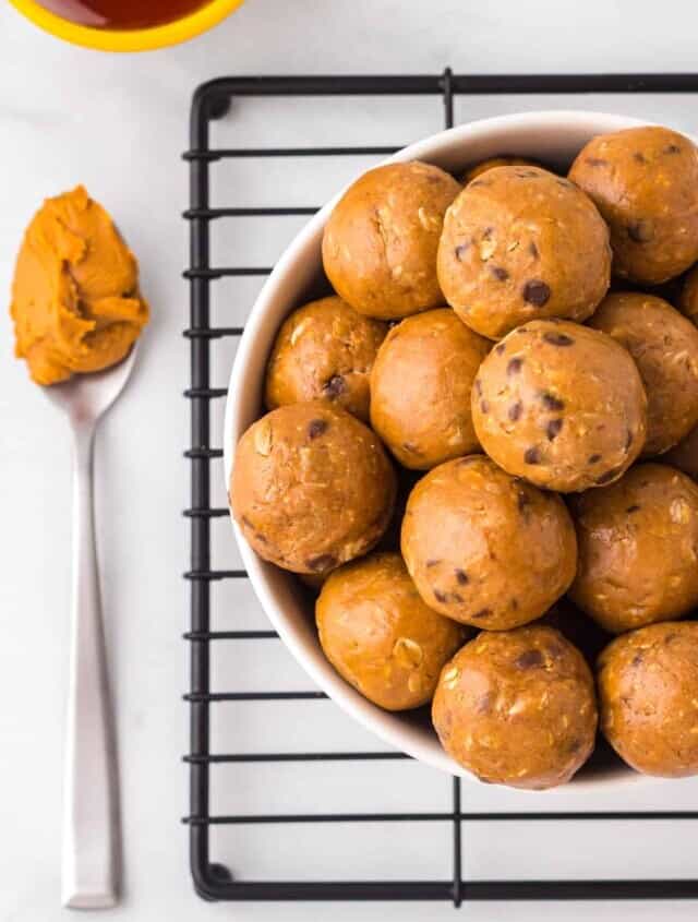 overhead image of chocolate peanut butter protein balls in a white bowl