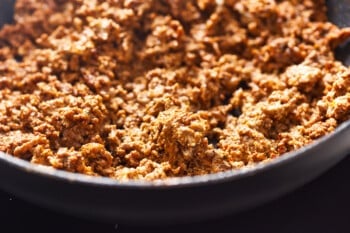 cooked seasoned ground beef with cream cheese in a skillet.