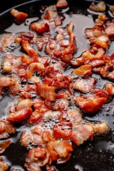 chopped bacon cooking in a skillet