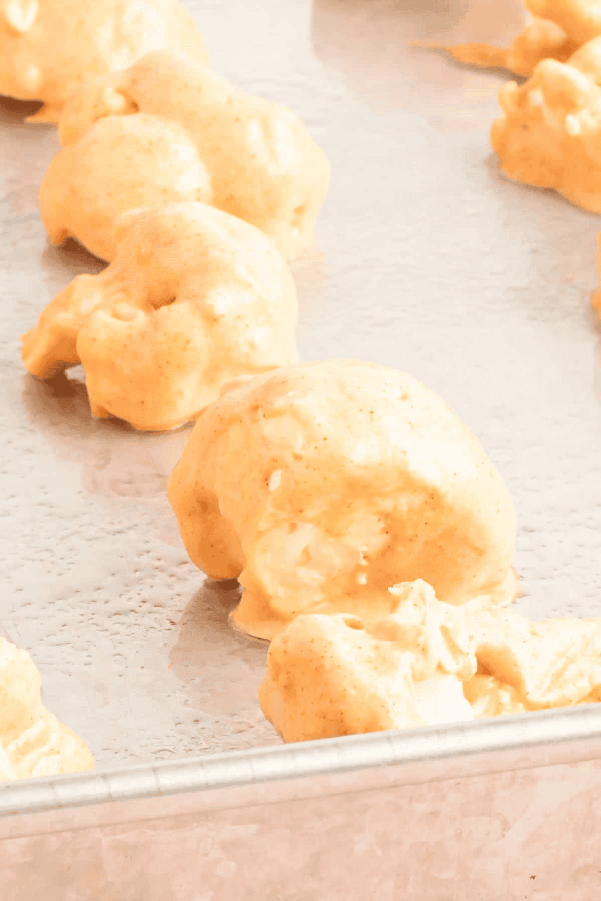 cauliflower coated wings on a baking sheet