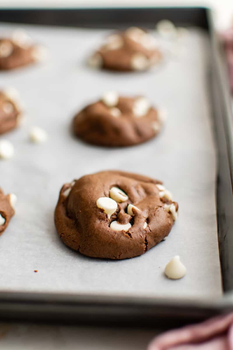 close up of a baked chocolate cake mix cookie on a baking sheet.