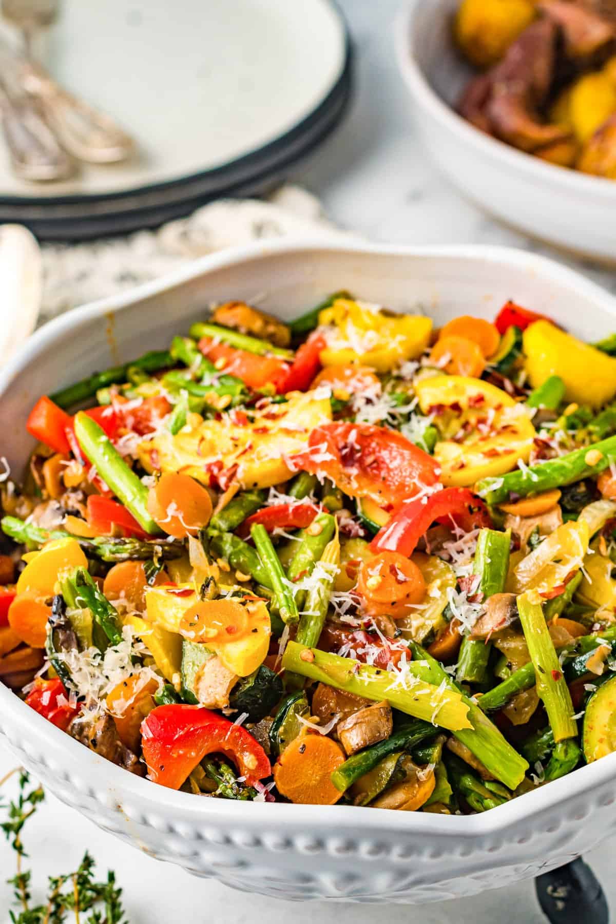 sauteed vegetables in a white serving bowl