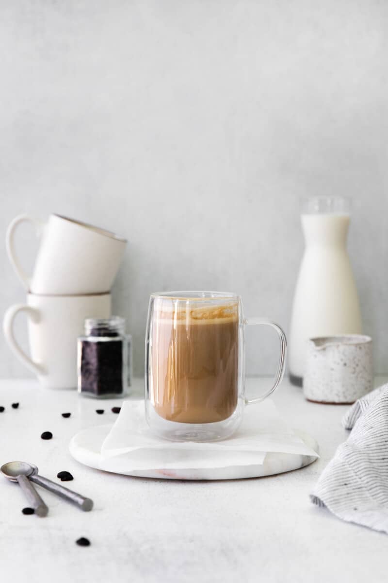 flat white drink in a glass mug