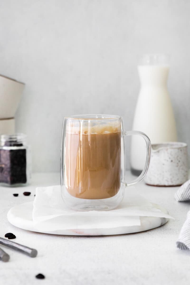 flat white drink in a glass mug