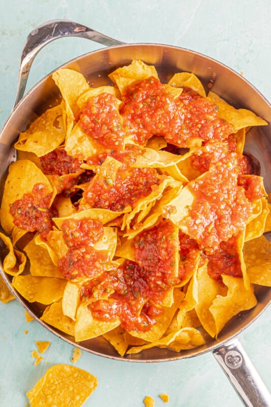 Chips and salsa in a sauté pan before cooking.