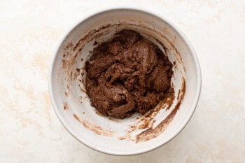 overhead view of chocolate cake mix cookie dough in a white bowl.