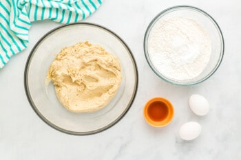 overhead view of wet ingredients, vanilla, flour, and eggs.
