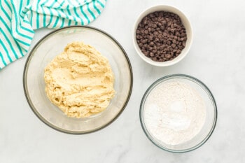 overhead view of dough with flour and chocolate chips.