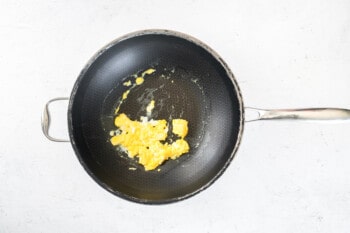 scrambled eggs in a wok.