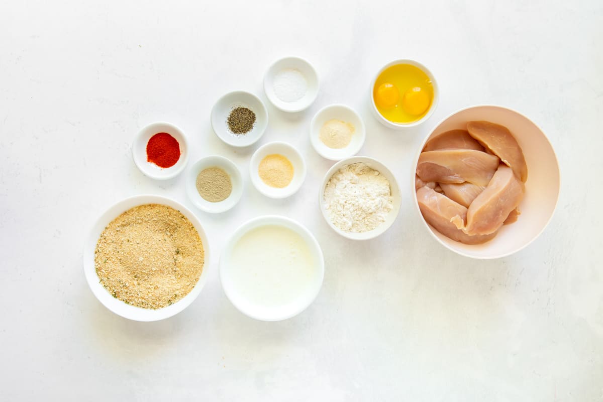 overhead view of ingredients for copycat raising canes chicken fingers in white bowls.