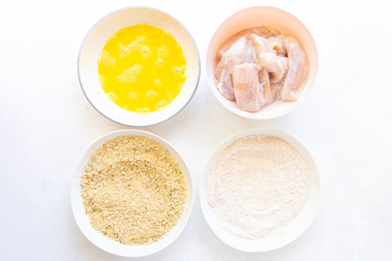 overhead view of dredging ingredients in white bowls.