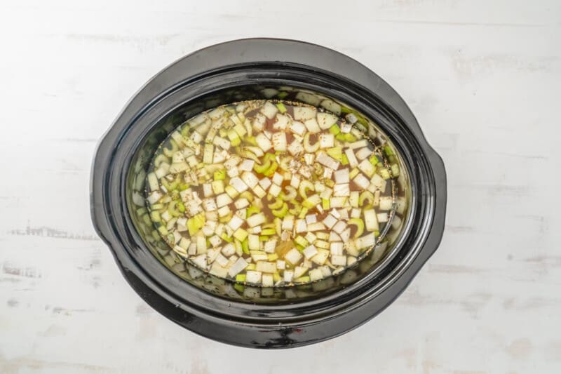 broth soaked mirepoix and chicken in a crockpot before cooking.