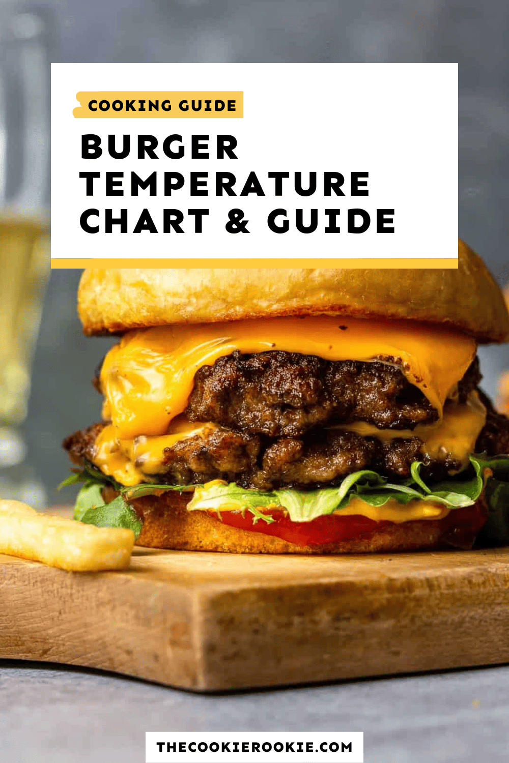 A burger cooking guide with temperature recommendations displayed on a cutting board.