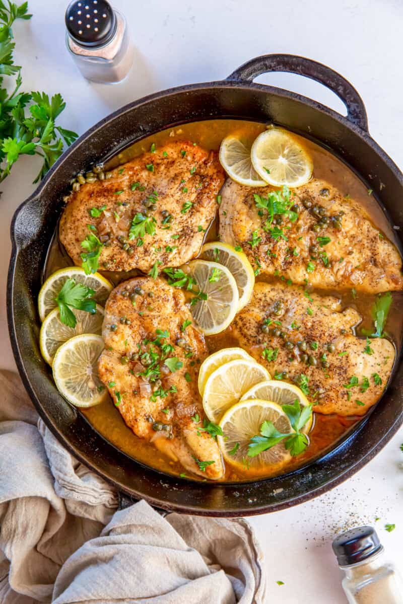 Overhead view of chicken piccata in a skillet.