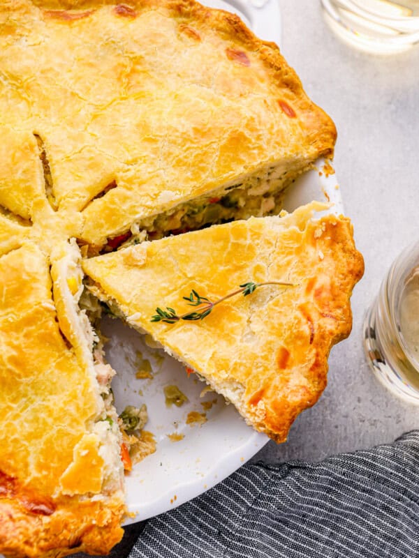 sliced chicken pot pie in a white pie pan.
