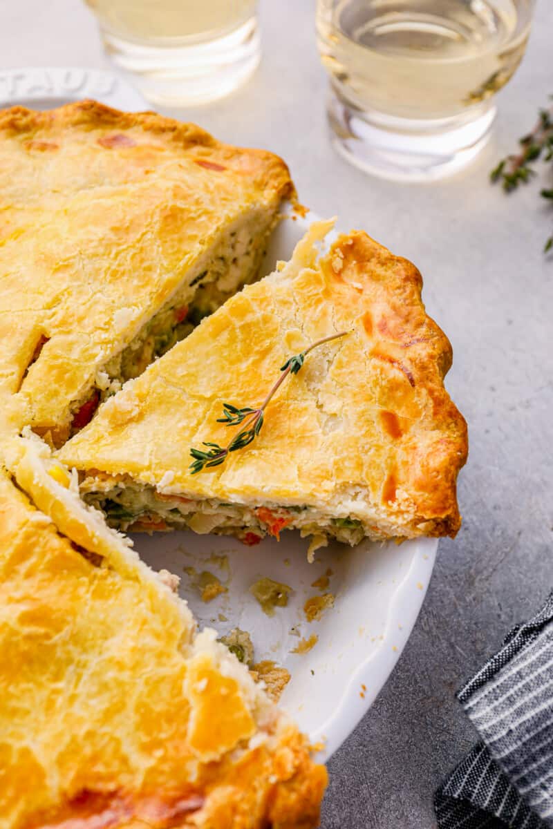 sliced chicken pot pie in a white pie pan.