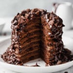 A delectable stack of chocolate pancakes, warm and fluffy, is delicately placed on a pristine plate. - 14