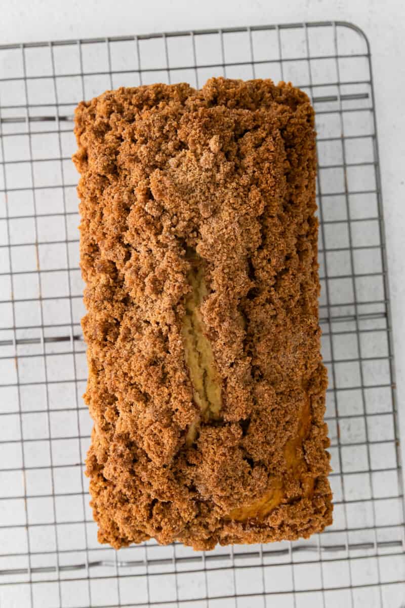 overhead view of cinnamon roll bread on a wire rack.